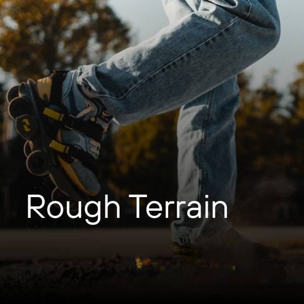 Person riding rugged electric skates on rough outdoor terrain.