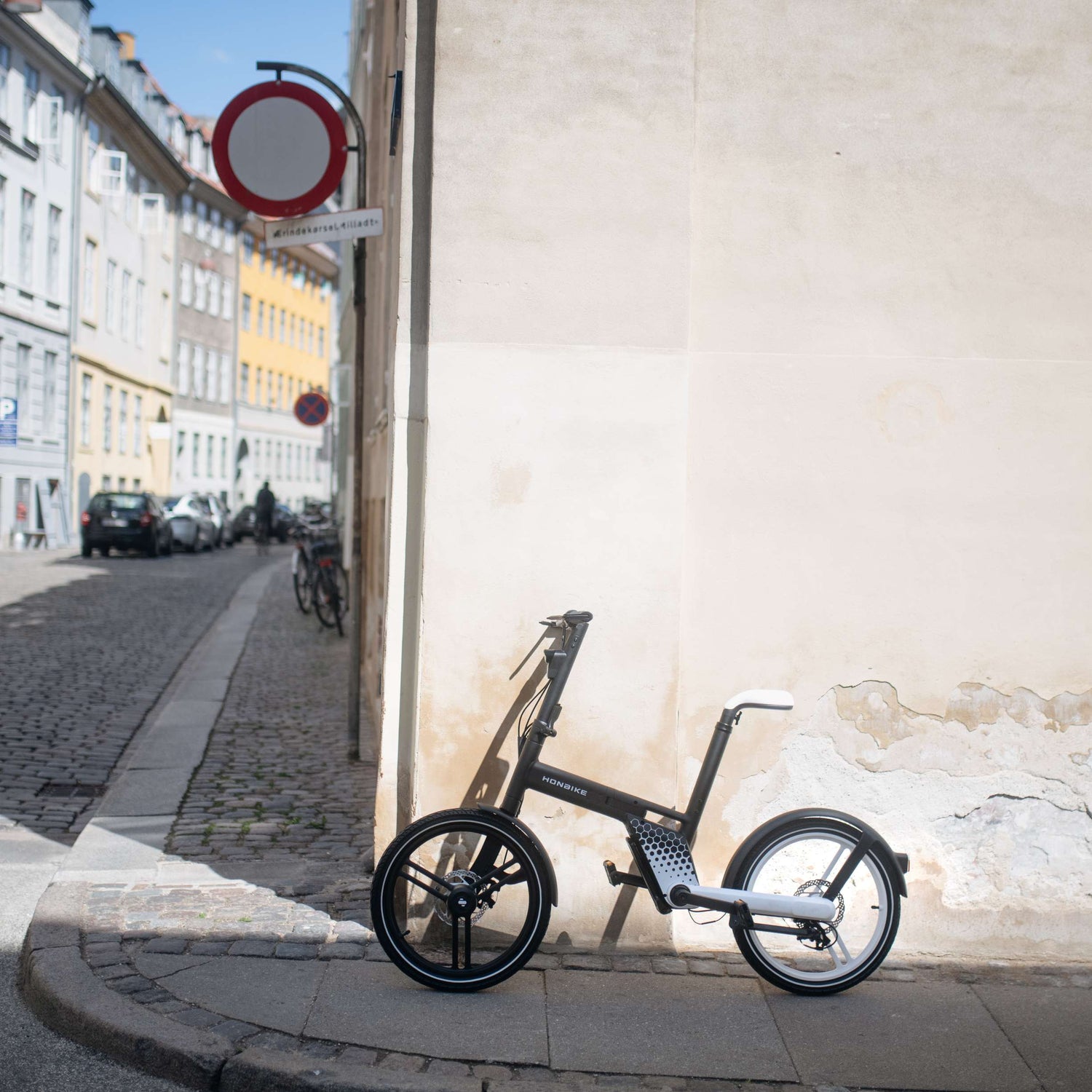 HONBIKE electric bike with sleek frame parked by wall