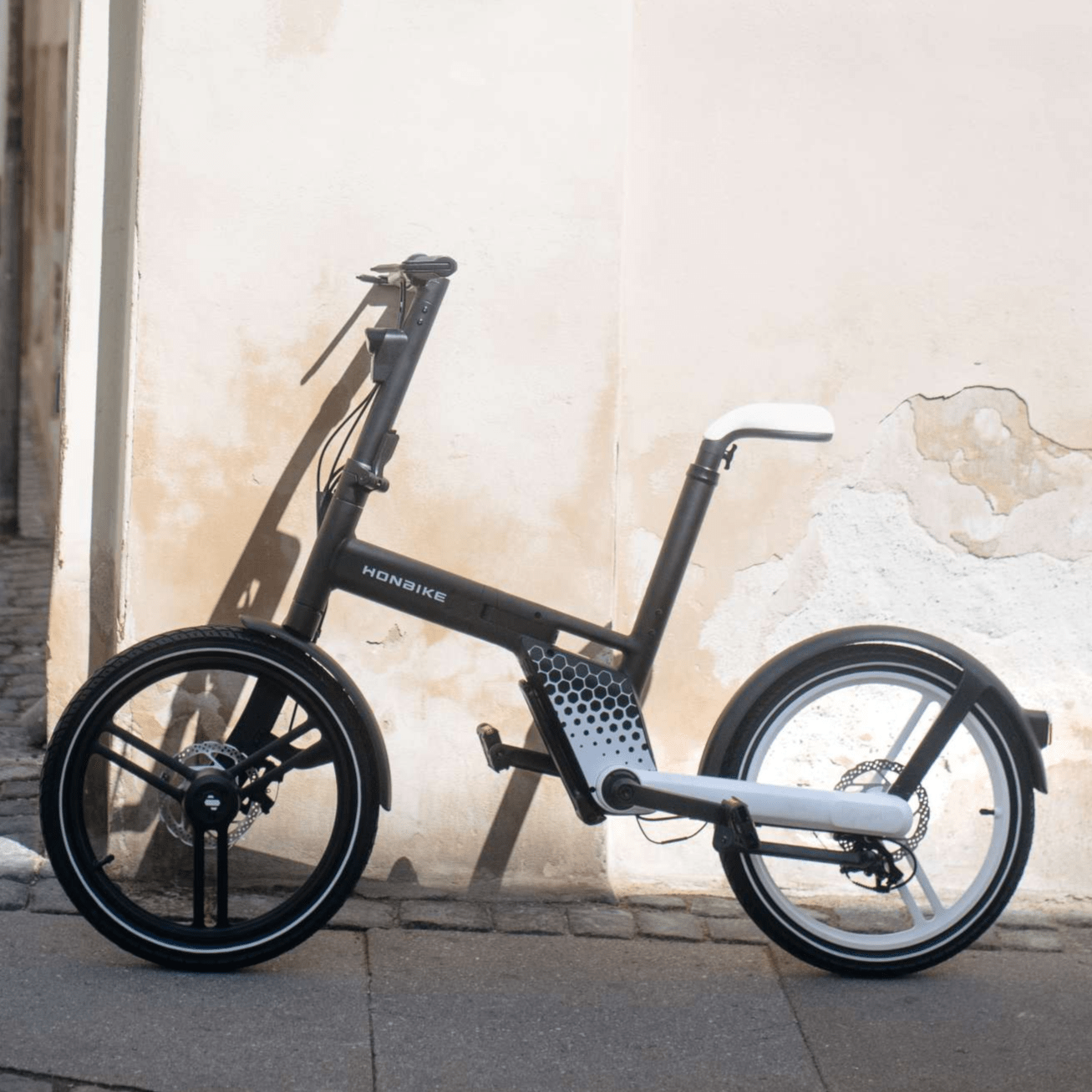 HONBIKE electric bike with sleek frame parked by wall