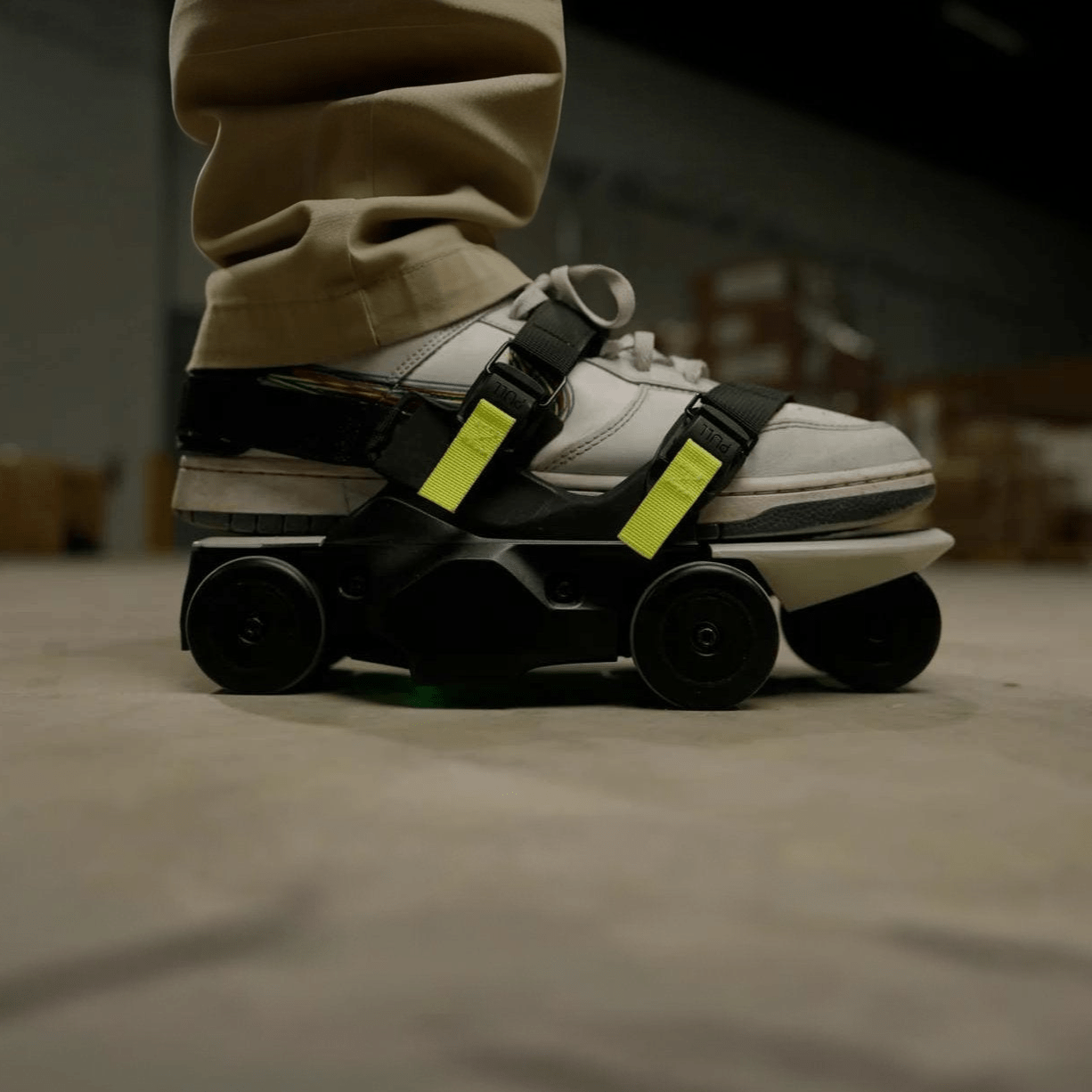 Close-up of motorized shoe worn indoors with yellow straps